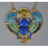 An enamelled yellow metal necklace with large winged scarab Egyptian-style pendant, marked “Thomas