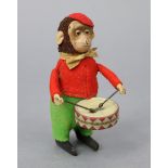 An early 20th century Schuco cloth-covered tinplate automaton monkey drummer character figure, 4½”