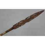 A large ethnic carved wooden ceremonial spear (w.a.f.).