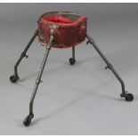 A 19th century French baby-walker, the crimson waist band on adjustable metal supports with