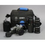 A Minolta “SRT 100” camera, with five lenses, & carrying case.