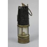 A Richard Johnson’s of Manchester & Liverpool brass & steel miner’s lamp, 9” high.