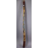 A painted & carved wooden didgeridoo inscribed “Burbirra, Lloyd Nolan”.