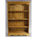 A pine standing open bookcase with three adjustable shelves, & on a plinth base, 36” wide x 54” high