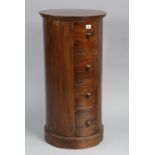 A teak three-drawer bedside chest of cylindrical form, 16” diameter x 33¼” high.