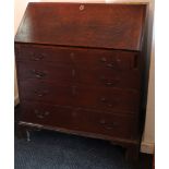 A 19th century oak bureau with fitted interior enclosed by fall-front above four long graduated