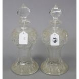 A pair of heavy cut-glass decanters, each of ovoid form & with finial stopper, 11” high.