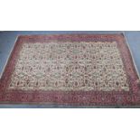 A Persian large rug of ivory ground & with repeating multi-coloured geometric design to