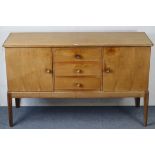 A GORDON RUSSELL OF BROADWAY WALNUT SIDEBOARD fitted three long drawers to centre flanked by