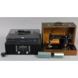 A Teac cd/record player with remote control; & a Singer hand sewing machine, with case.