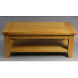 A light oak rectangular two-tier low coffee table on square legs, 47½” wide x 18½” high x 23½”