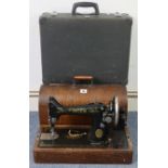 A Singer hand sewing machine with oak case; & a Globetrotter fibre-covered suitcase, 17¾” wide.