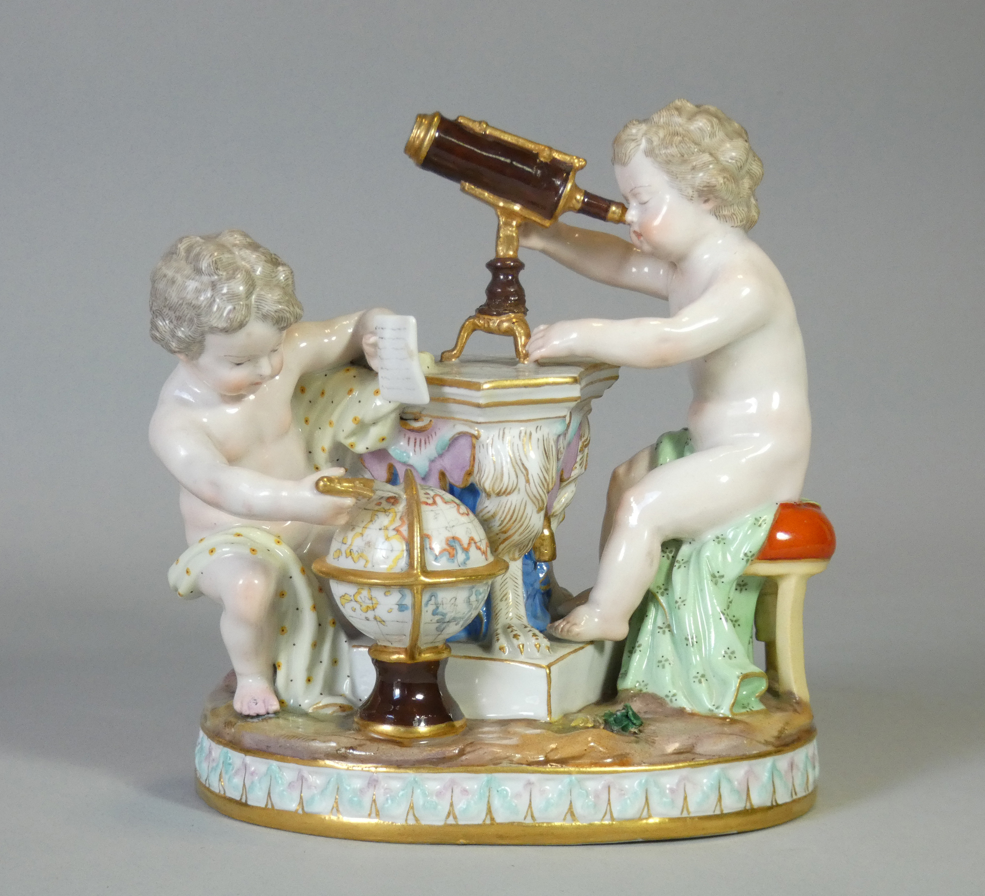 A Meissen porcelain figure group emblematic of astronomy, with two putti – one looking through a