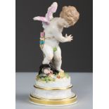 A Meissen porcelain standing figure of Cupid, his right leg caught in a gin-trap, on round simulated