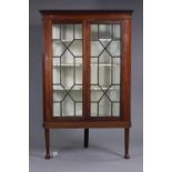 A Georgian mahogany large corner display cabinet with moulded dentil cornice, fitted three shaped