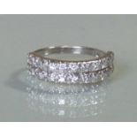 A diamond half-hoop ring set twenty-two small stoned arranged in two rows, to an un-marked white