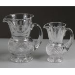 Two Edinburgh Crystal Thistle pattern graduated water jugs, 14.75 cm & 18cm high.