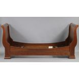 A French cherrywood sleigh bed retailed by Liberty of London, with scrolled head & foot boards,