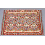 A Choli Kilim rug of bright multicoloured repeating geometric design within a narrow border, 33”