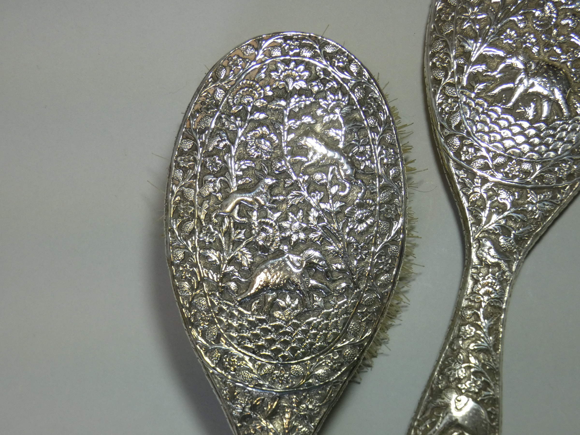 A late 19th/early 20th century Indian silver-backed hand mirror & matching hairbrush, with all- - Image 3 of 4