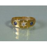 An 18ct gold ring, gypsy-set with a small diamond to the square matrix, a small sapphire either