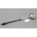 A George II punch ladle with oval bowl & turned wood handle, 13¼” long; London 1750, by William