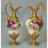 A pair of Royal Worcester porcelain ewers of inverted pear shape, with painted rose decoration by