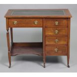 An early 20th century inlaid mahogany kneehole writing desk, inset gilt-tooled green leather to