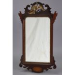 A George II-style rectangular wall mirror in fret-carved mahogany veneered frame with gilt ho-ho