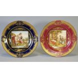 Two ‘Vienna’ porcelain cabinet plates, one of deep blue ground, the other claret, each with raised