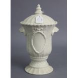 A Belleek porcelain large two-handled ribbed vase & cover, with oval cartouche bordered by a