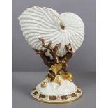 A Royal Worcester porcelain nautilus vase of ivory ground, on coral & seaweed support & circular