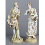 A pair of late 19th century continental painted bisque large standing male & female figures