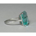 AN AQUAMARINE RING, the emerald-cut stone weighing approx. 7carats, set to an un-marked white