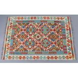 A Choli kilim rug, of ivory ground with repeating multicoloured geometric design surrounded by