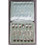 A set of twelve Edwardian silver teaspoons with embossed shell terminals, London 1908, by Carrington