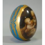 A 19th century RUSSIAN PORCELAIN EGG, finely painted with a scene of Joseph with infant Christ after