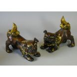 A pair of 20th century bronzed figures of foo dogs, with gilt manes & tails, each 6¼” long x 5½”