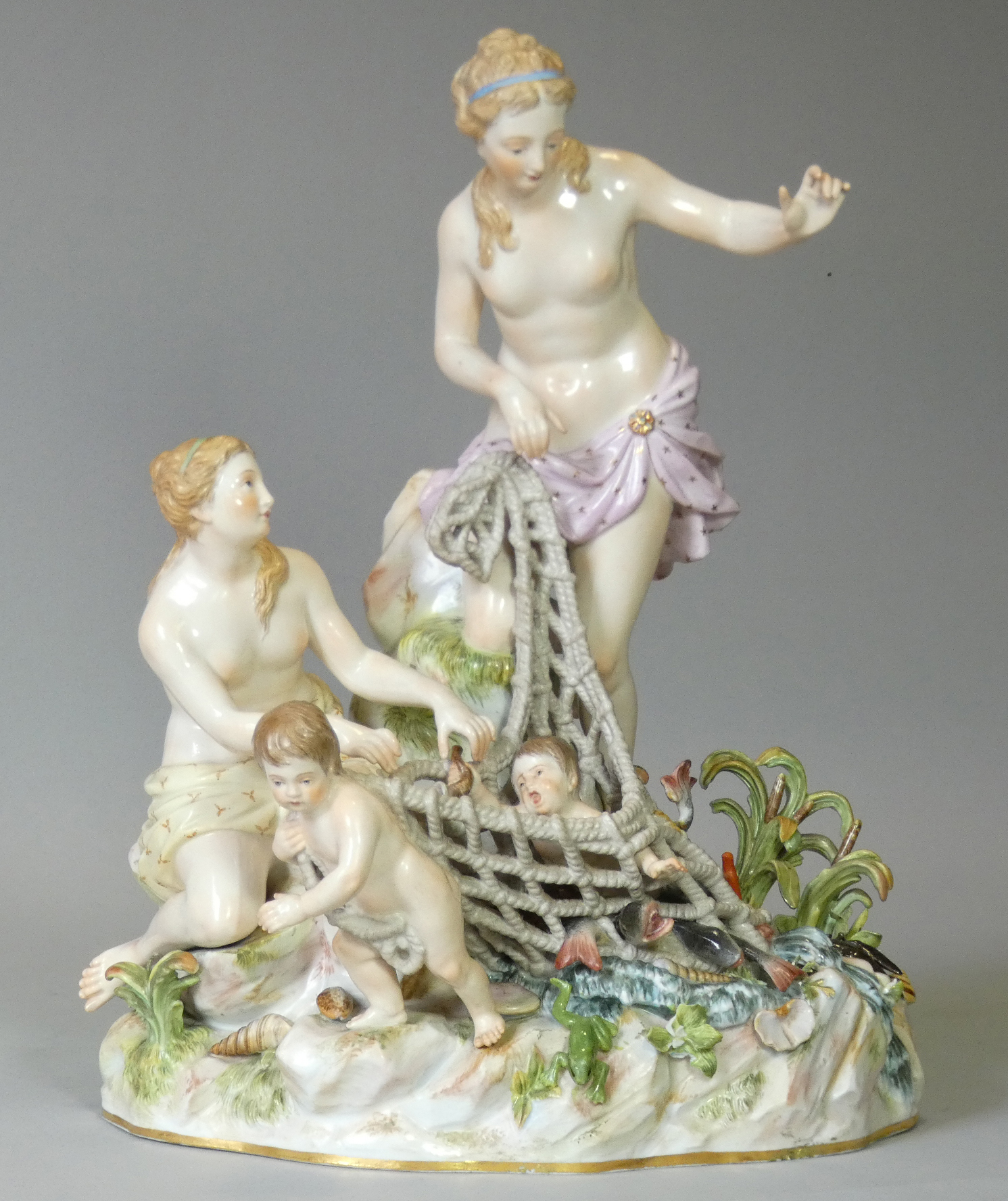 A MEISSEN PORCELAIN FIGURE GROUP ‘CAPTURING THE TRITONS’, depicting Venus, a female attendant &