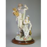 A Berlin porcelain figure group depicting Orpheus standing next to Minerva (seated), with cupid