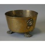 A 19th century brass coal bucket with lion-mask & ring side handles, on three lion-paw feet; 11½”
