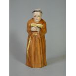 A Royal Worcester candle snuffer in the form of a Monk reading a book, printed mark (date code for