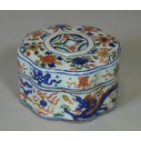 A Chinese porcelain box of lobed circular form, decorated in woven woucai enamels with dragons