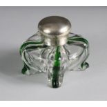 A late Victorian silver-mounted glass inkwell of compressed bombé form, quartered by green vertical