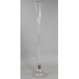 An unusually large clear glass floor-standing trumpet vase, on bell-shaped pedestal foot; 57” high.