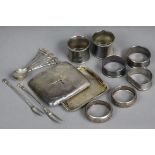 Seven various silver napkin rings; a silver cigarette case (w.a.f.); & a set of foreign coffee
