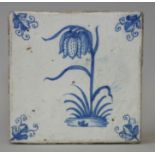 A 17th century Dutch delft blue & white flower tile painted with a snake’s head fritillary; 5¼”