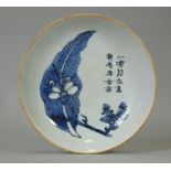 A Chinese blue & white porcelain shallow bowl, painted to the centre with foliage & calligraphy,