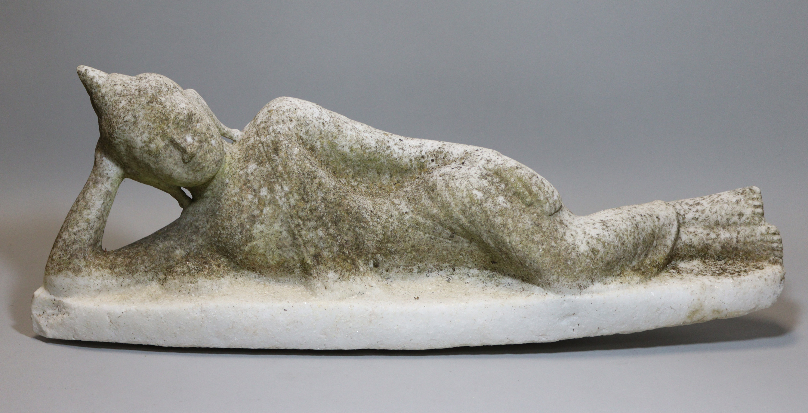 A carved alabaster buddhistic statue of a reclining figure, " long.