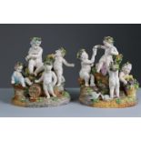 A pair of continental porcelain Bacchanalian figure groups, each depicting four putti pouring &